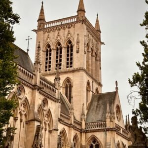 A stunning Gothic Revival church towering in Cambridge, England, amidst overcast skies.