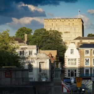 Beautiful view of Norwich Castle and cityscape under a dramatic sky with clouds.